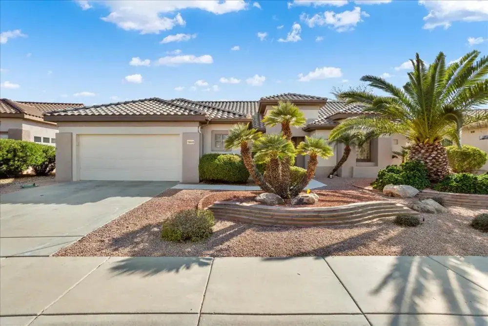 Single story desert home with a tile roof and palm landscaping for the Home Buyers Overview in Arizona